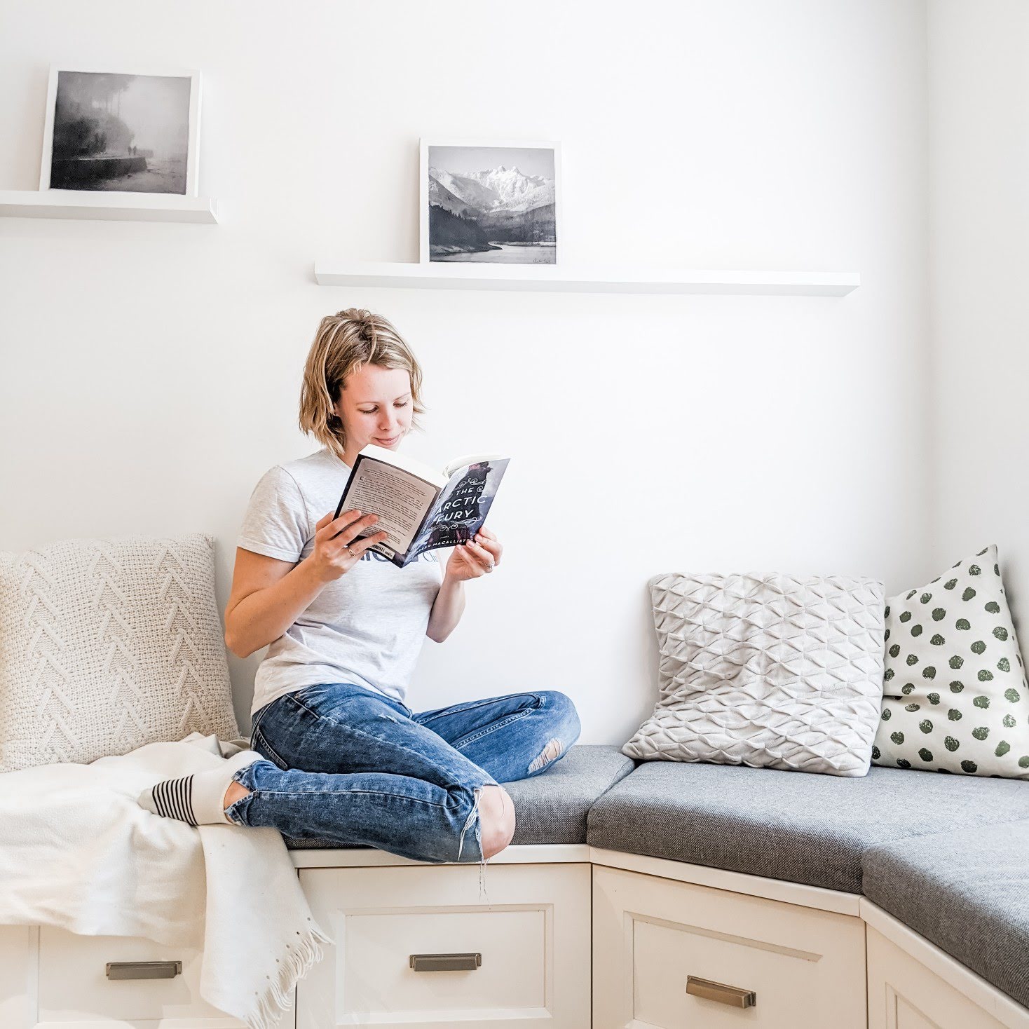 Girl reading in a book nook 